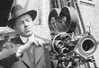 Man in hat cranks camera